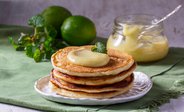 istock Whole grain flour fritters served with lime curd on a light background. Rustic style. 1498499671