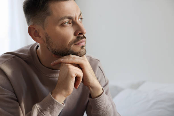 istock Upset man sulking at home, space for text. Loneliness concept 1498500519