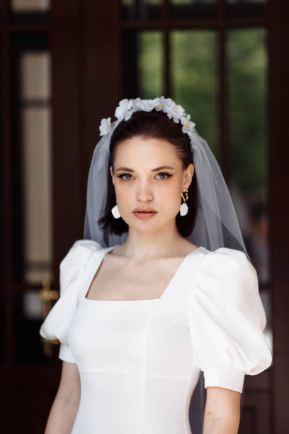 portrait of a beautiful bride in a white dress with a veil and a hoop of flowers. portrait of a beautiful bride in a white dress smiling with a veil and a hoop of flowers. hoops wedding stock pictures, royalty-free photos & images