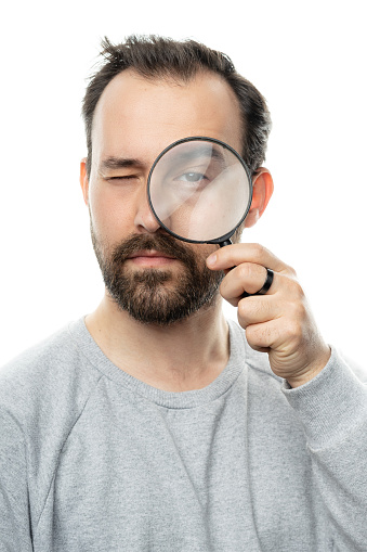 portrait, white background, magnifying glass