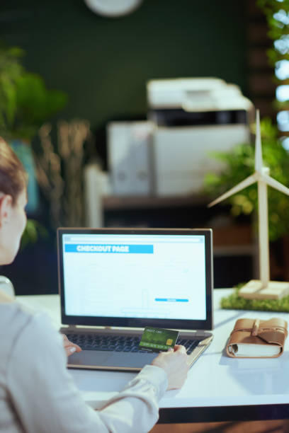 istock Seen from behind female making online shopping 1498502633