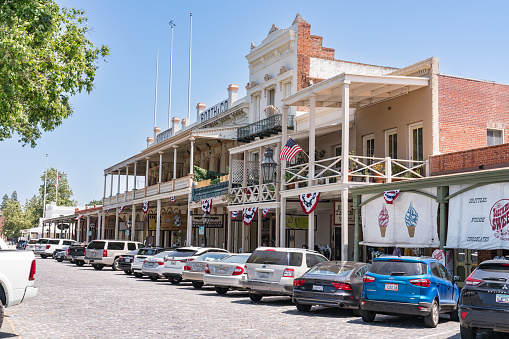Sacramento, CA - May 25, 2023: Historic buildings line the street in Old Town Sacramento located near the waterfront of the city of Sacramento, California.