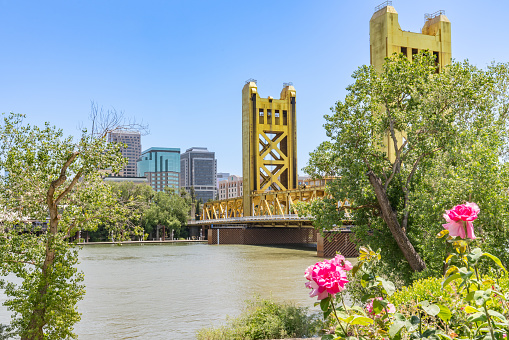 Sacramento, CA - May 25, 2023: City skyline and Tower Bridge of Sacramento from the Riverwalk Trail
