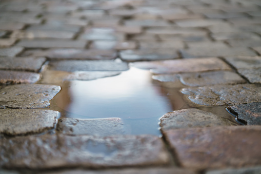 puddle on old stone pavement background, high detailed