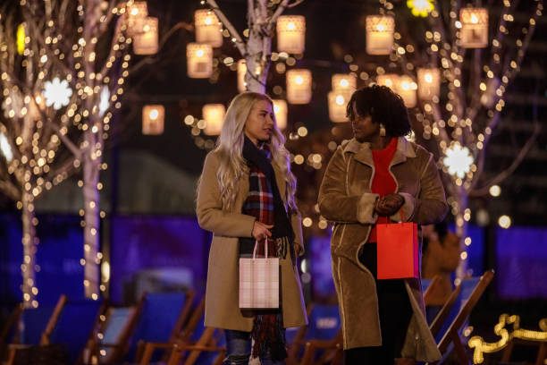 istock Two girlfriends chatting and walking through the Christmas park 1498506967