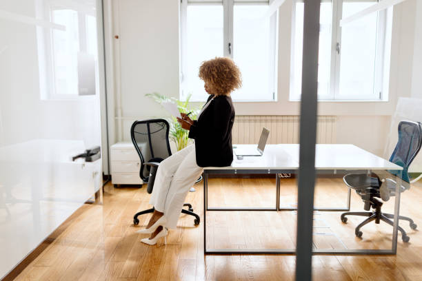 istock Woman making plans in the modern office 1498510183