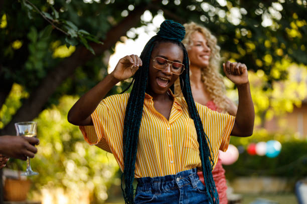 Young women dancing and having fun at the garden party