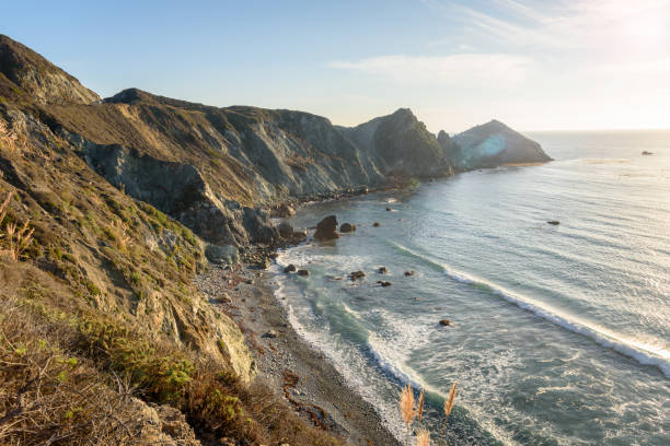 秋の夕暮れ時の壮大な岩だらけの海岸線 - travel destinations rocky coastline moody sky clear sky ストックフォトと画像