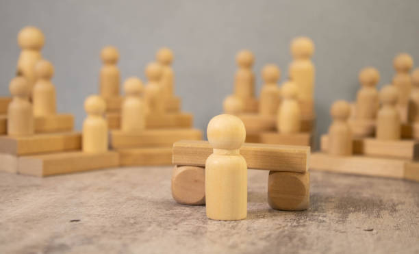 istock wooden mannequin standing behind a tribune. concept 1498518714