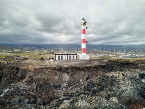 An aerial view of a picturesque lighthouse in El Poris de Abona, a charming coastal village