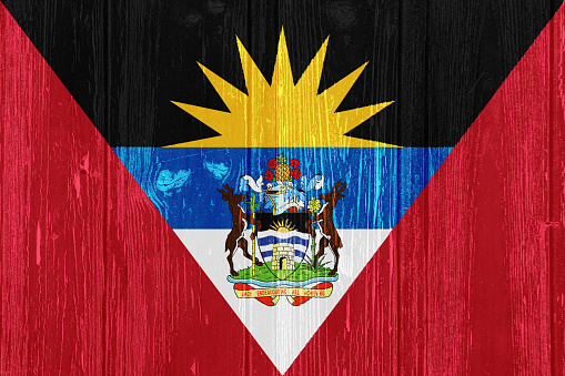 Flag of Antigua and Barbuda on a textured background. Concept collage.