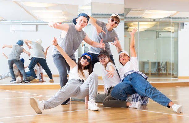 Teens hip hop dancers posing in studio