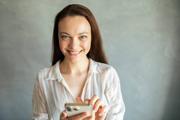 istock Young woman using a smart phone at home 1498527561