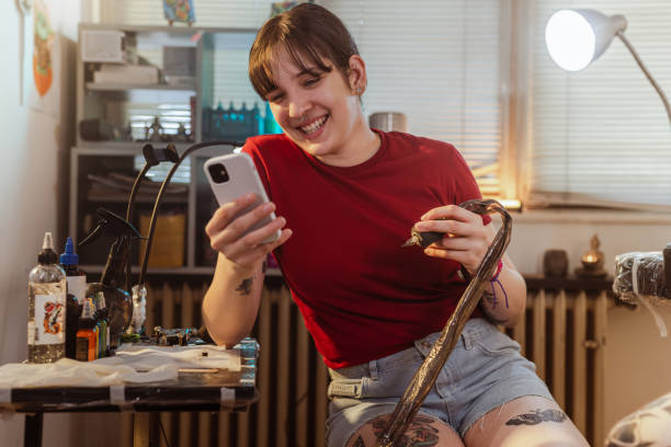 istock Tattoo shop owner using a smart phone 1498528723
