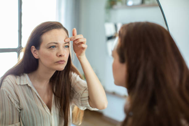 istock Young woman looking at a mirror at home 1498528778