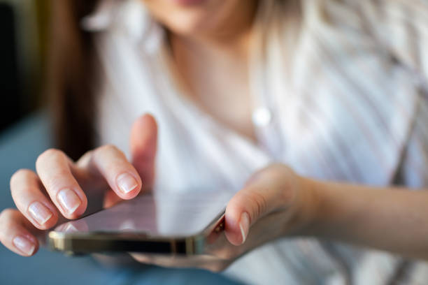 istock Young woman using a mobile phone at home 1498529080