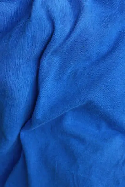 Photo of fabric from a piece of crumpled blue cloth