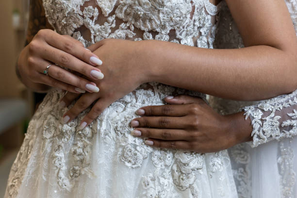 istock Two women in wedding dresses holding hands 1498529897