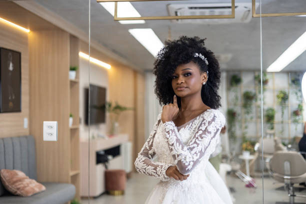 istock Black woman dressed as a bride in beauty salon 1498530480