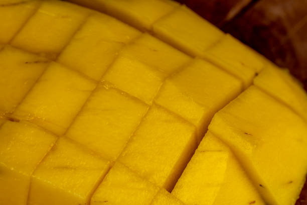 istock sliced ripe mango fruit on a board, close-up 1498530707