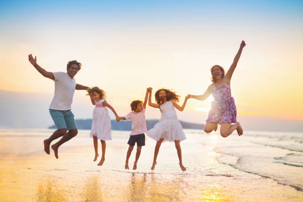 istock Family walking on tropical beach at sunset 1498530795