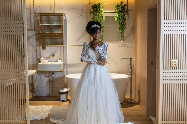 Black woman dressed as a bride in a hotel room