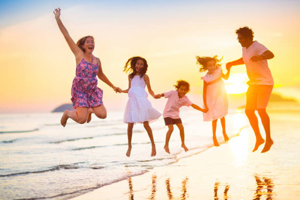 istock Family walking on tropical beach at sunset 1498530924