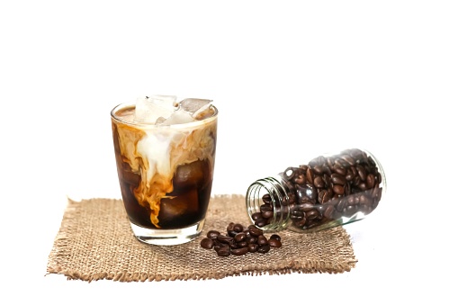 Latte ice coffee and coffee beans are spread around the glass  with menu latte concept isolated picture