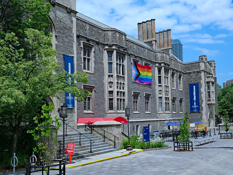Toronto, Canada - June 13, 2023:  University of Toronto, Hart House students' recreational and cultural building, with Gay Pride banner