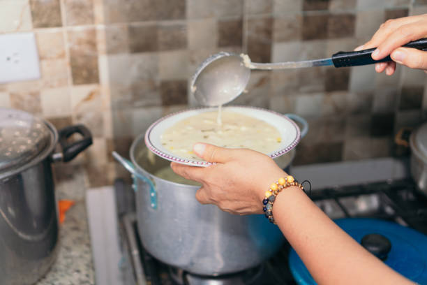 Woman serving food onto a plate.