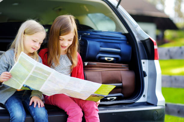 istock Two adorable little sisters exploring a map before going on vacations with their parents 1498538930