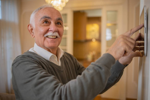 istock Man locking the door with an automated security system 1498539774