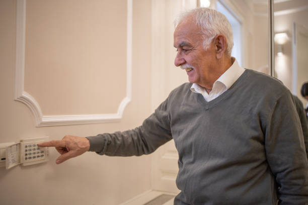 istock Man locking the door with an automated security system 1498539777