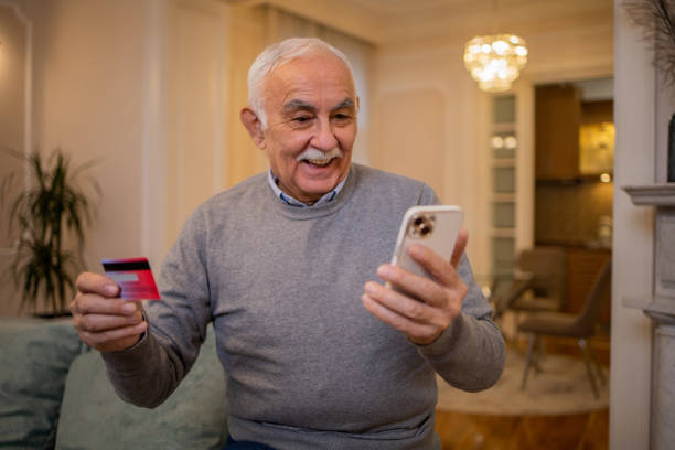 istock Cheerful man doing online shopping 1498539807