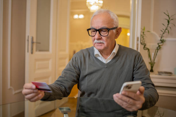 istock Cheerful man doing online shopping 1498539810