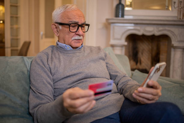 istock Cheerful man doing online shopping 1498539855