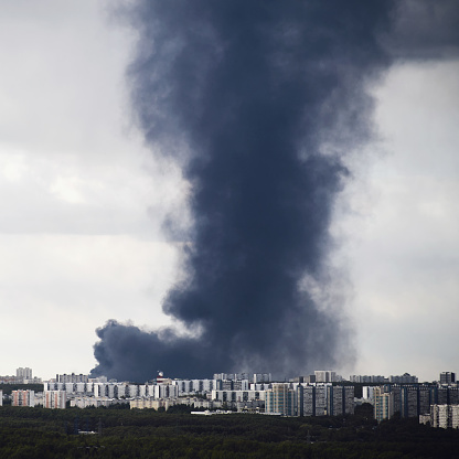 Thick black smoke emanated from a fire in Russia, shrouding Moscow's residential buildings in darkness and mingling with the clouds in the sky.