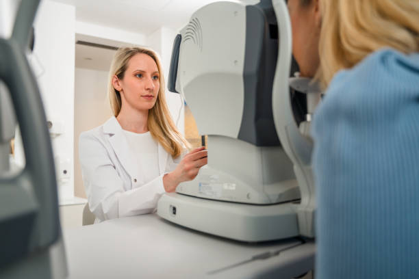 istock Female Optometrist Looking Into Patient's Eye 1498542398