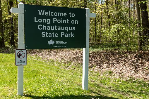 Beemus Point, New York, USA May 11, 2023 The Welcome to Long Point on Chatuauqua State Park sign on a sunny spring day