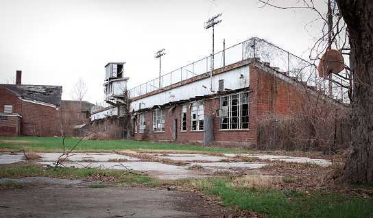 An abandoned stadium with a rusty basketball hoop in Tallulah, Louisiana