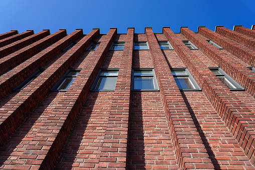 Low angle view of brick building against clear blue sky