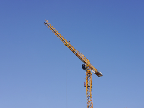 Low angle view of a construction crane against blue sky