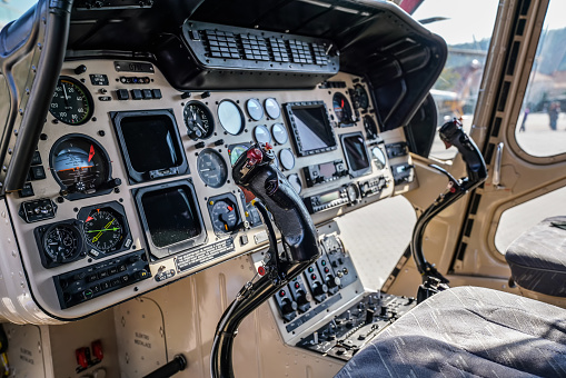 Brno, Czechia - October 08, 2021: Cockpit interior of helicopter with cyclic stick, flight control and instrument panels. Demonstration for public at defence fair