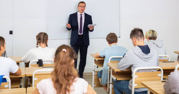 istock Adult teacher is giving lecture for students in class 1498557735