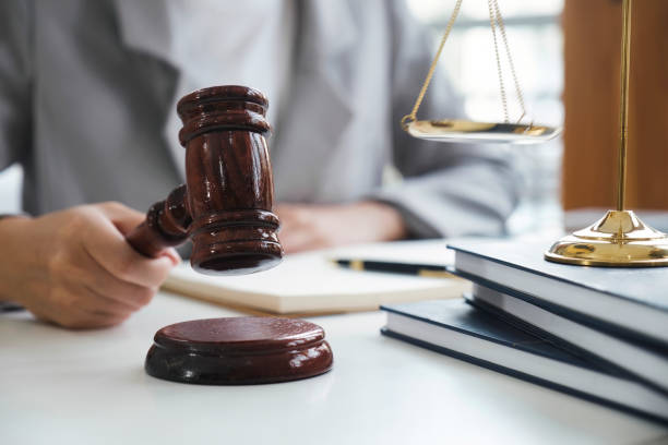 istock Business woman in suit or lawyer working on a documents. 1498559512