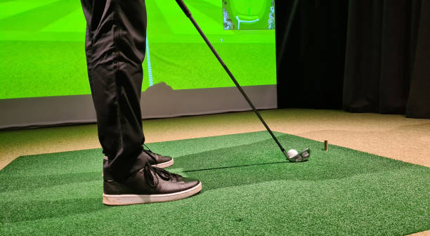 istock Male golfer plays golf indoors on golf simulator closeup 1498564311