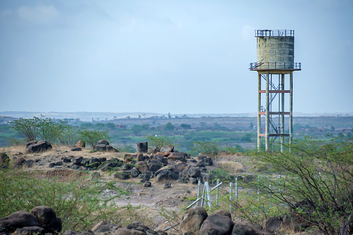 Pune, India - June 11 2023: An overhead water tank in an open field at Kedgaon village near Pune India.