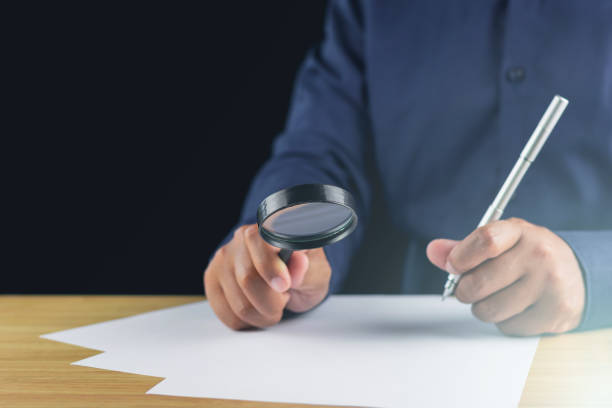 istock The man creates new idea by magnifying glass and pen. Research and development concept. 1498567209