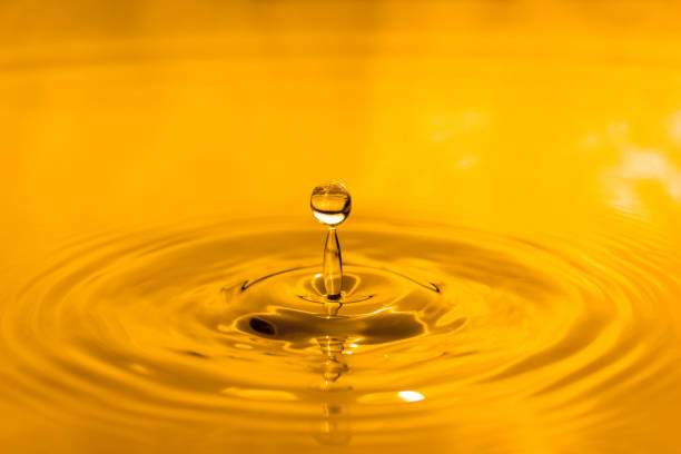yellow drop oil , Liquid gold oil drop ripple background