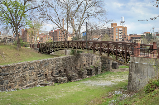 A view of the townscape of Columbus, Georgia with a bridge over a spillway